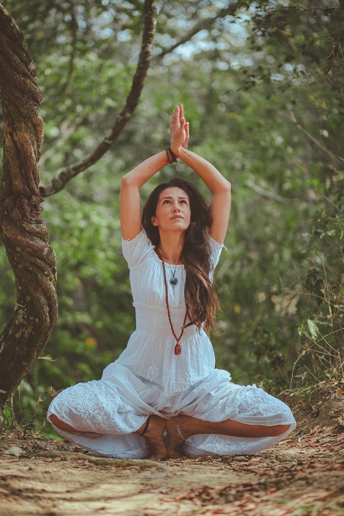 gallery-04 Woman meditating in a peaceful forest setting, embracing calmness and balance.